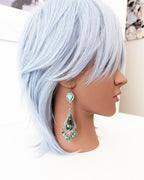 Long fringe earrings with Black Jack and Kingman turquoise stones on mannequin for scale