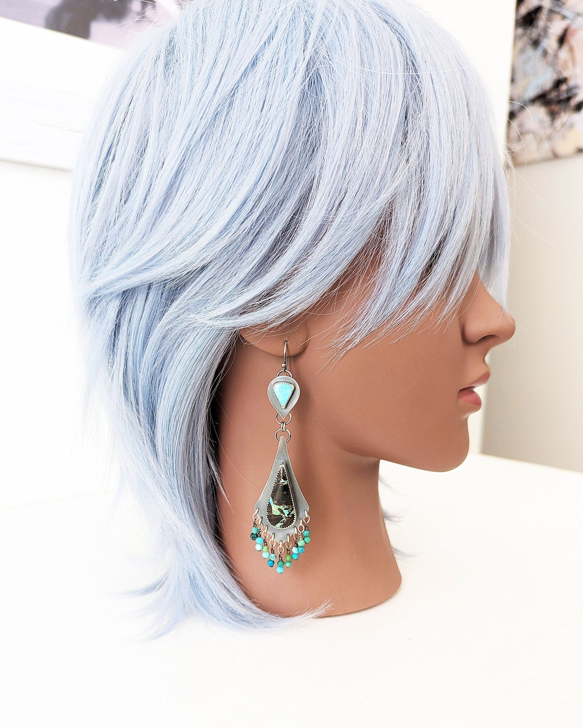 Long fringe earrings with Black Jack and Kingman turquoise stones on mannequin for scale