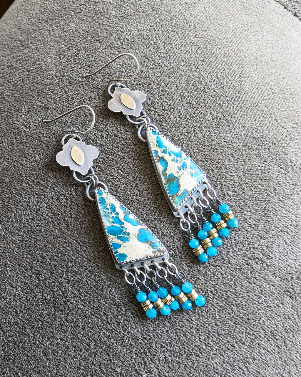 Collector gemstone earrings with balanced fringe movement