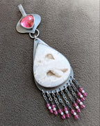 Close up of pear shaped white agate necklace with pink quartz bail