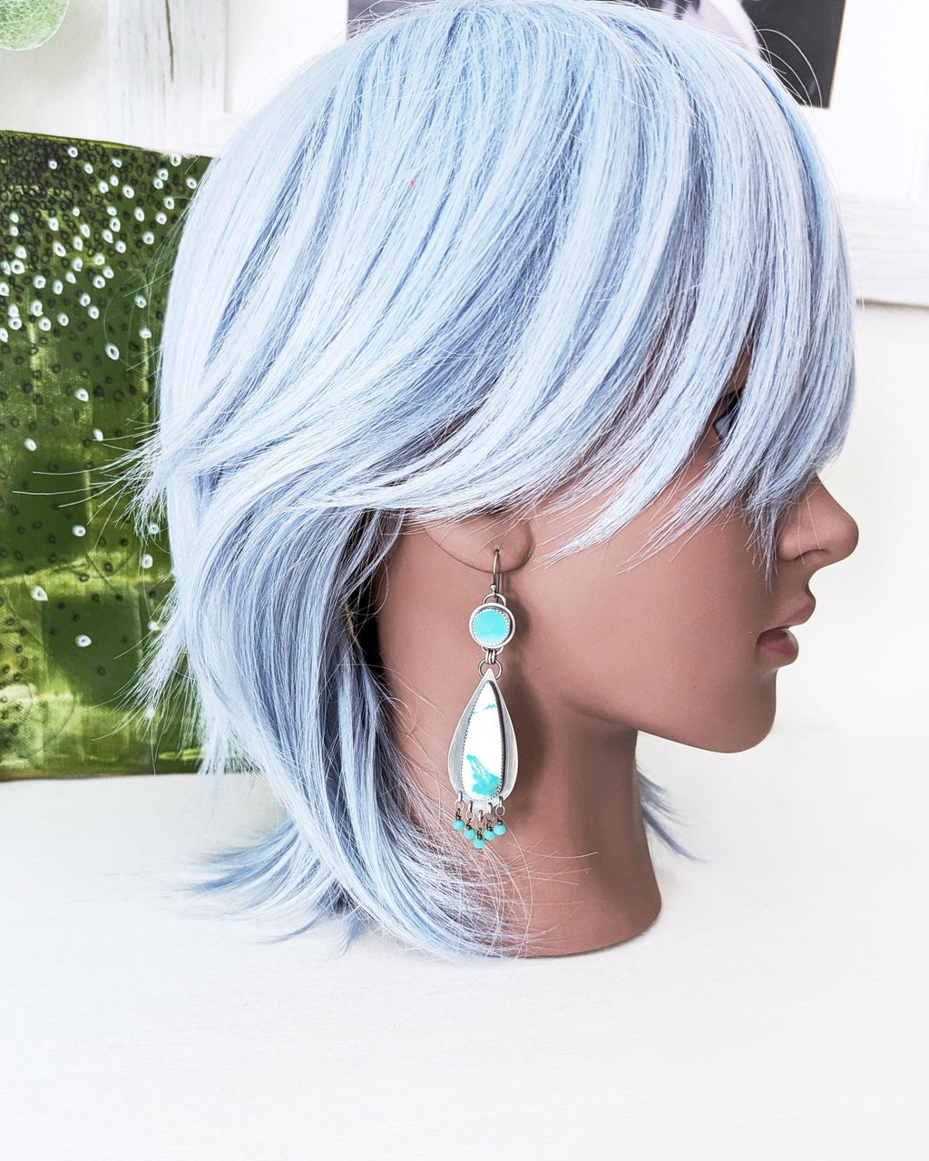 handmade artisan earrings shown on mannequin for scale by Rebellenhaus