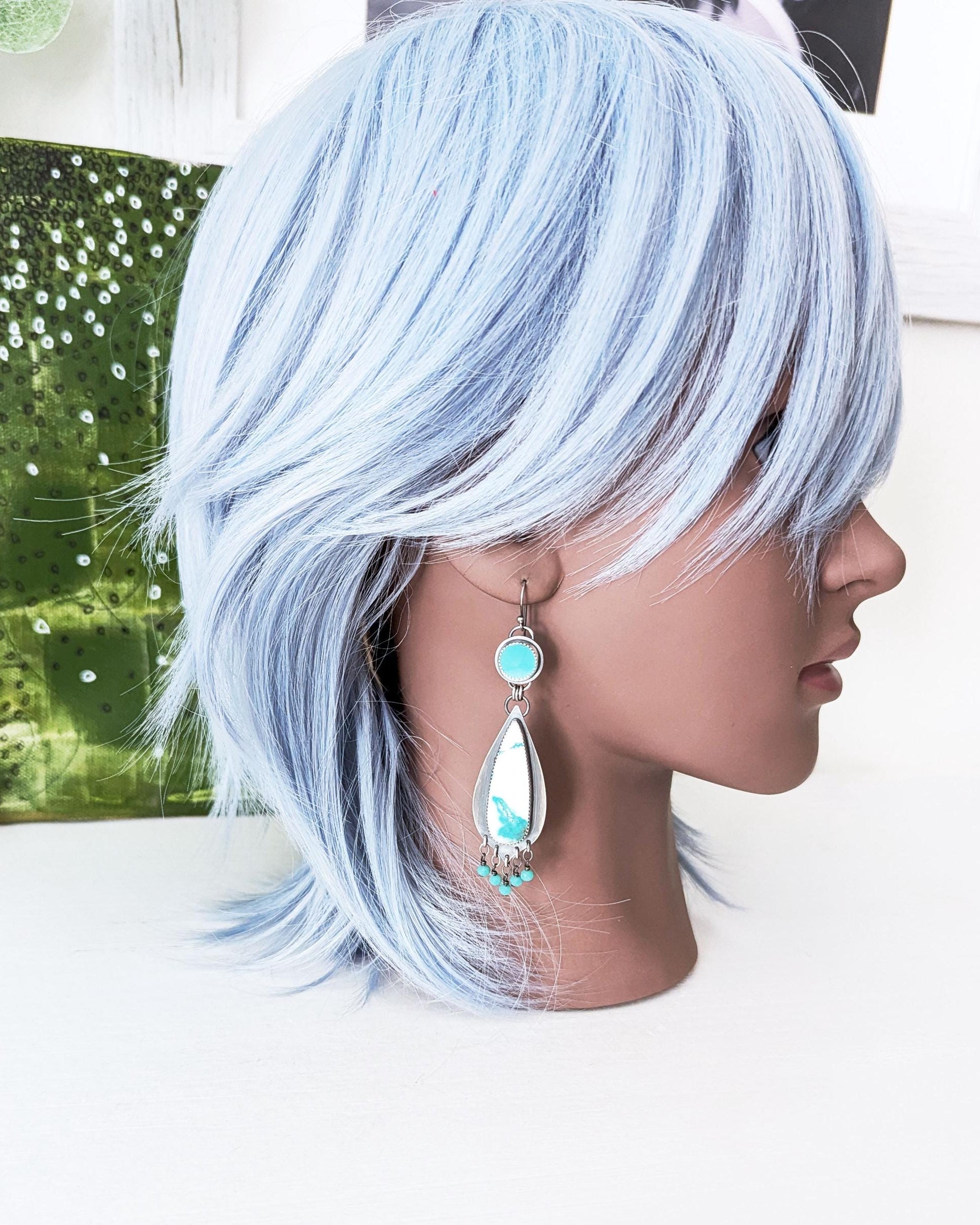 handmade artisan earrings shown on mannequin for scale by Rebellenhaus