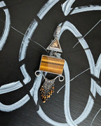 Earthy boho chic pendant featuring tiger’s eye and smoky quartz tones