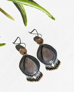 Artisan handmade moonstone earrings with antique brass accents in natural bright light