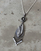 Contrasting statement pendant with moody artisan design shown on chain (not included)