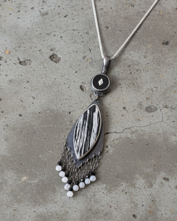 Contrasting statement pendant with moody artisan design shown on chain (not included)