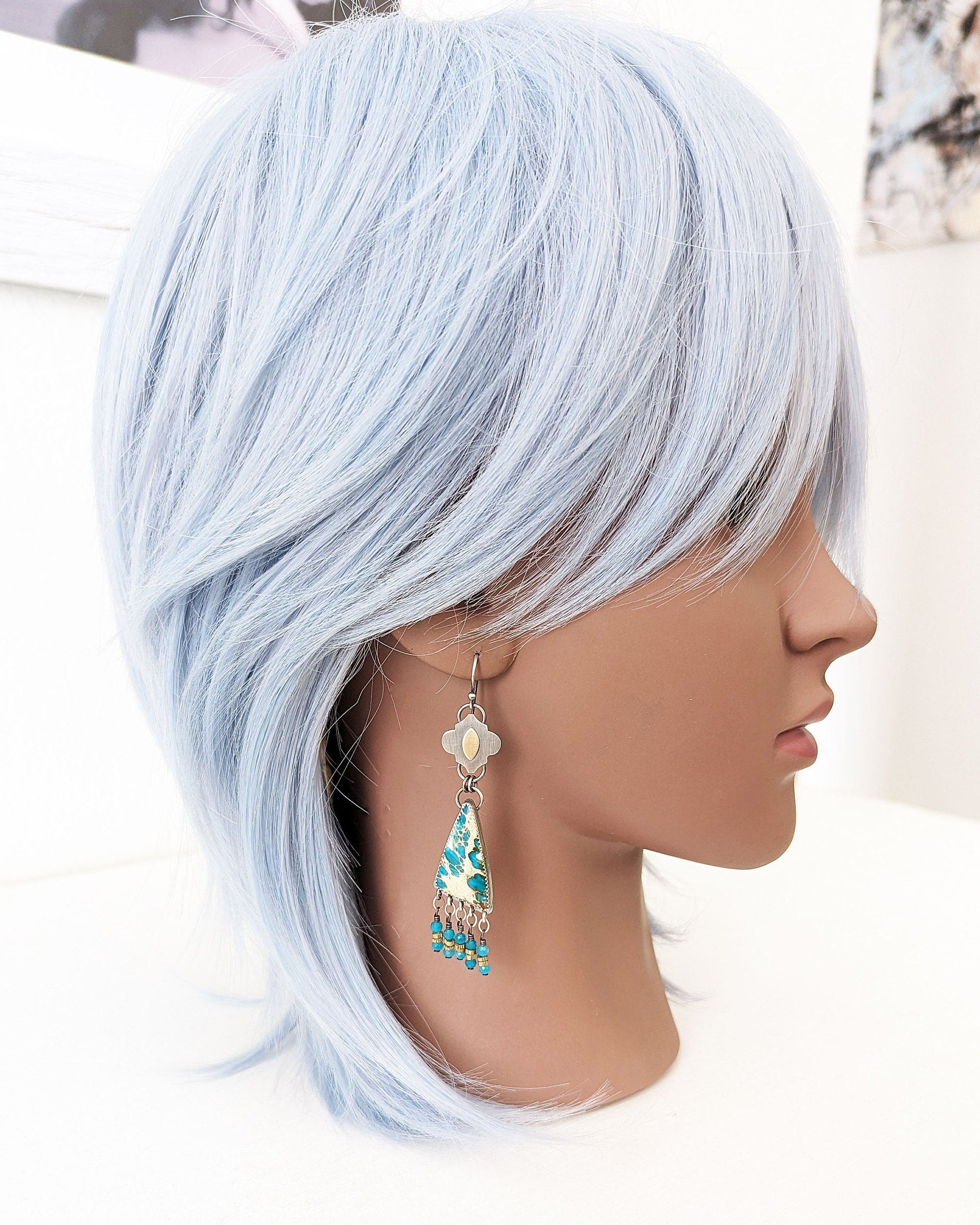 Bohemian sterling silver earrings featuring teal and beige stone on mannequin for scale