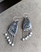 Close-up of black and white palm root agate stones with natural dotted pattern
