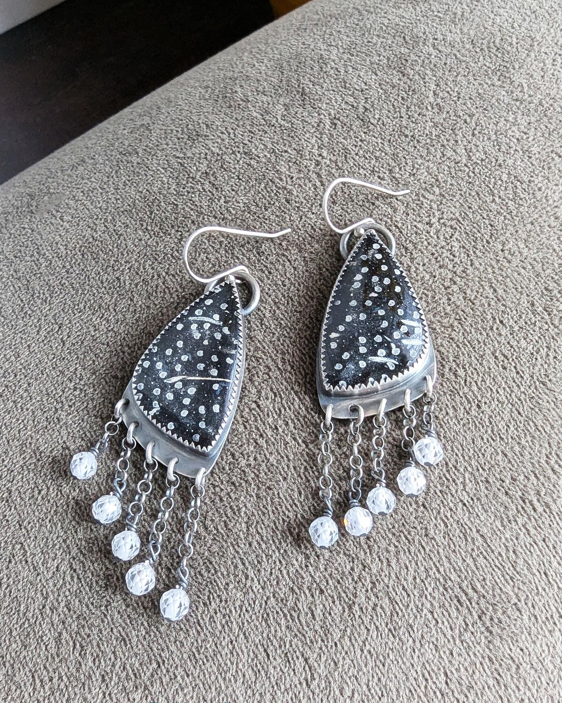 Close-up of black and white palm root agate stones with natural dotted pattern
