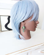 Bold neon-inspired statement earrings with playful shimmer
