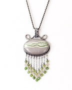Horizontal oval serpentine pendant with lime green vein on chain (not included)