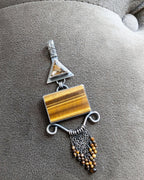 Golden statement pendant with triangular rutile quartz bail and tiger’s eye center
