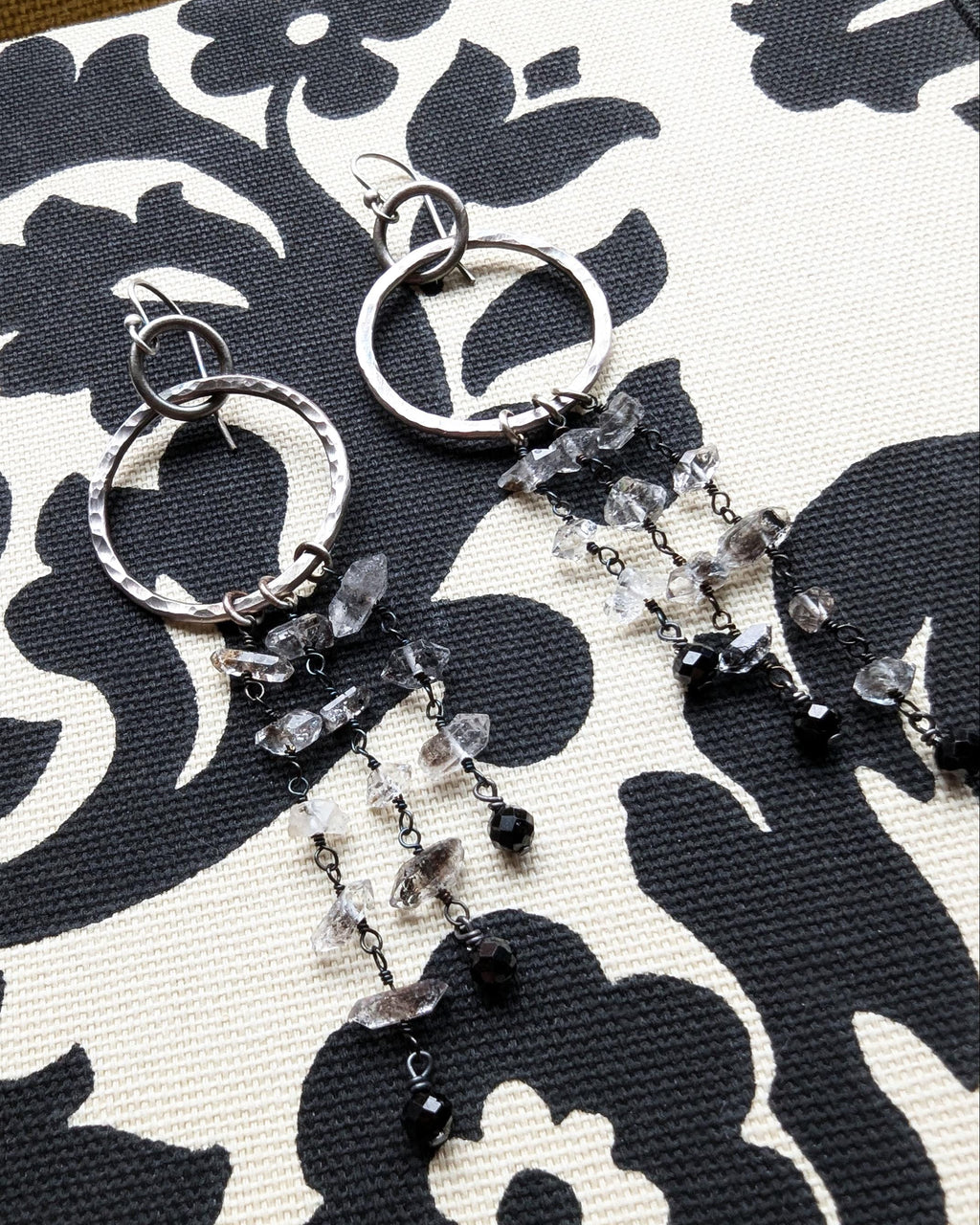 Close-up of Herkimer diamond quartz crystal drops with natural double-terminated points on fabric
