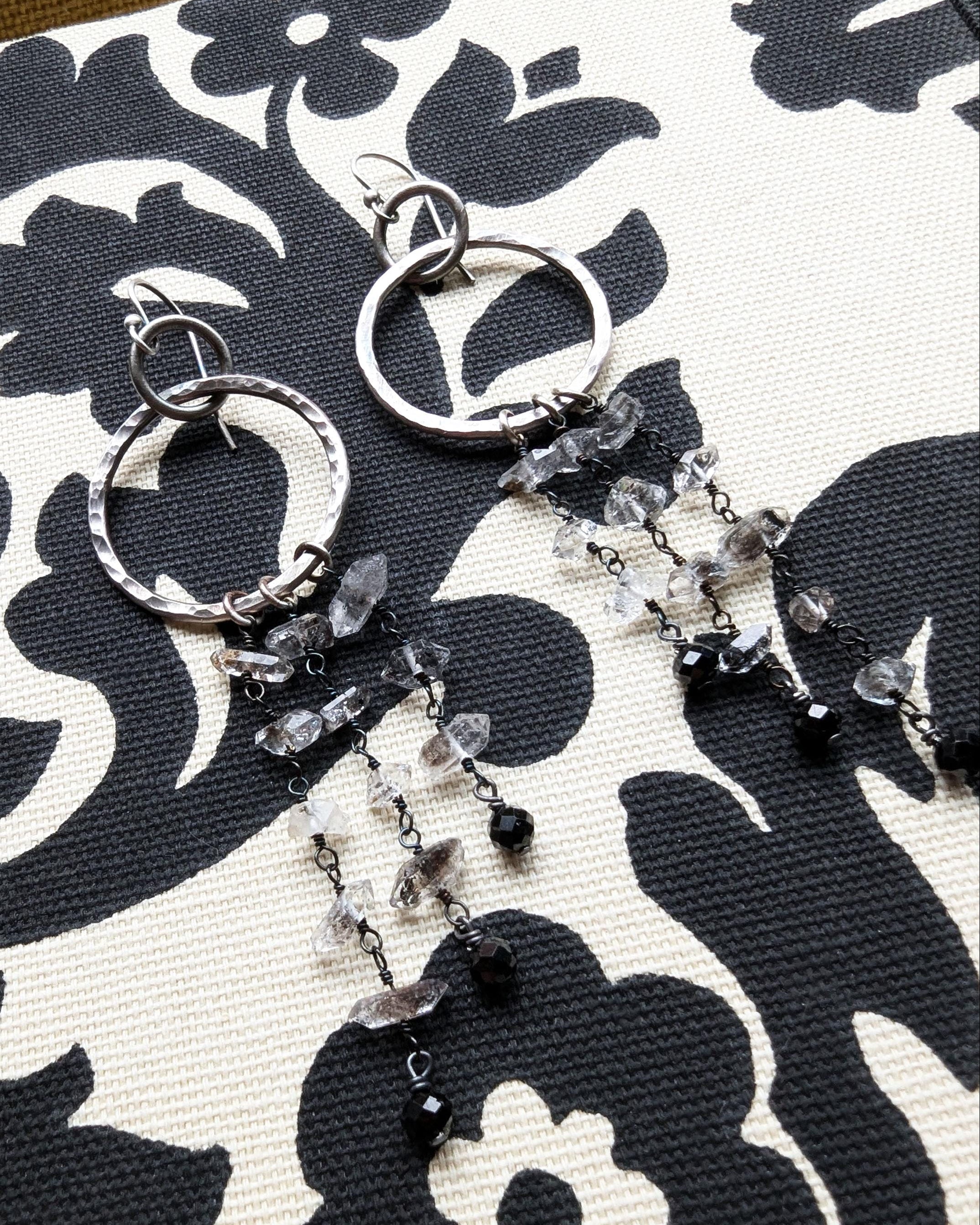 Close-up of Herkimer diamond quartz crystal drops with natural double-terminated points on fabric
