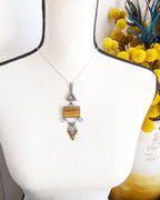 One of a kind star rutile quartz and tiger’s eye pendant by Rebellenhaus shown on bust (chain not included)