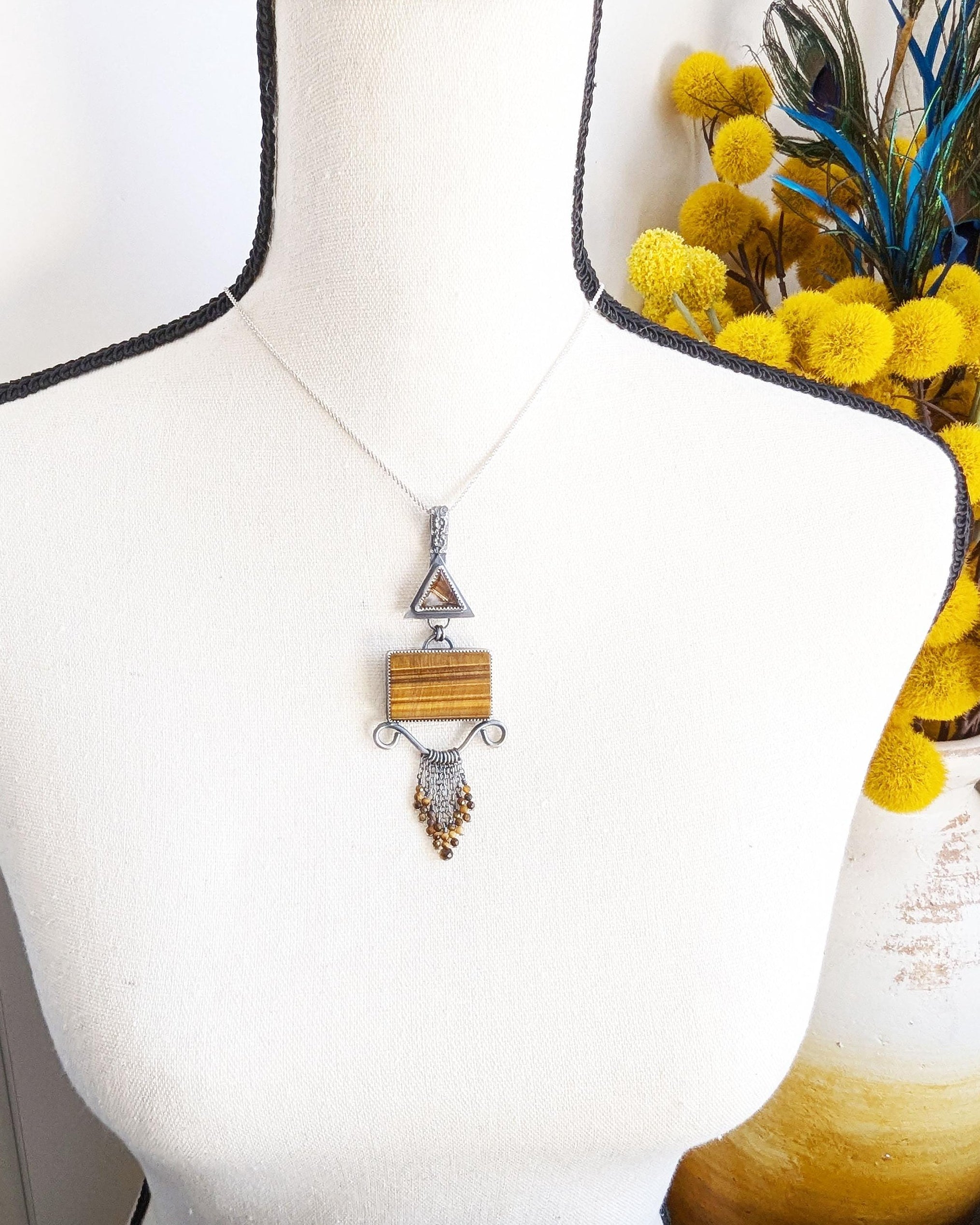 One of a kind star rutile quartz and tiger’s eye pendant by Rebellenhaus shown on bust (chain not included)