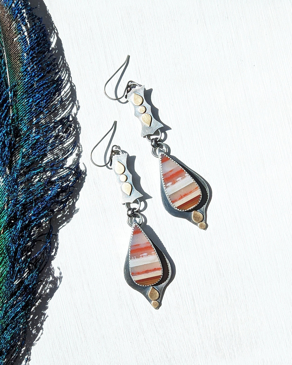 Collector artisan earrings showcasing striped opalized wood detail