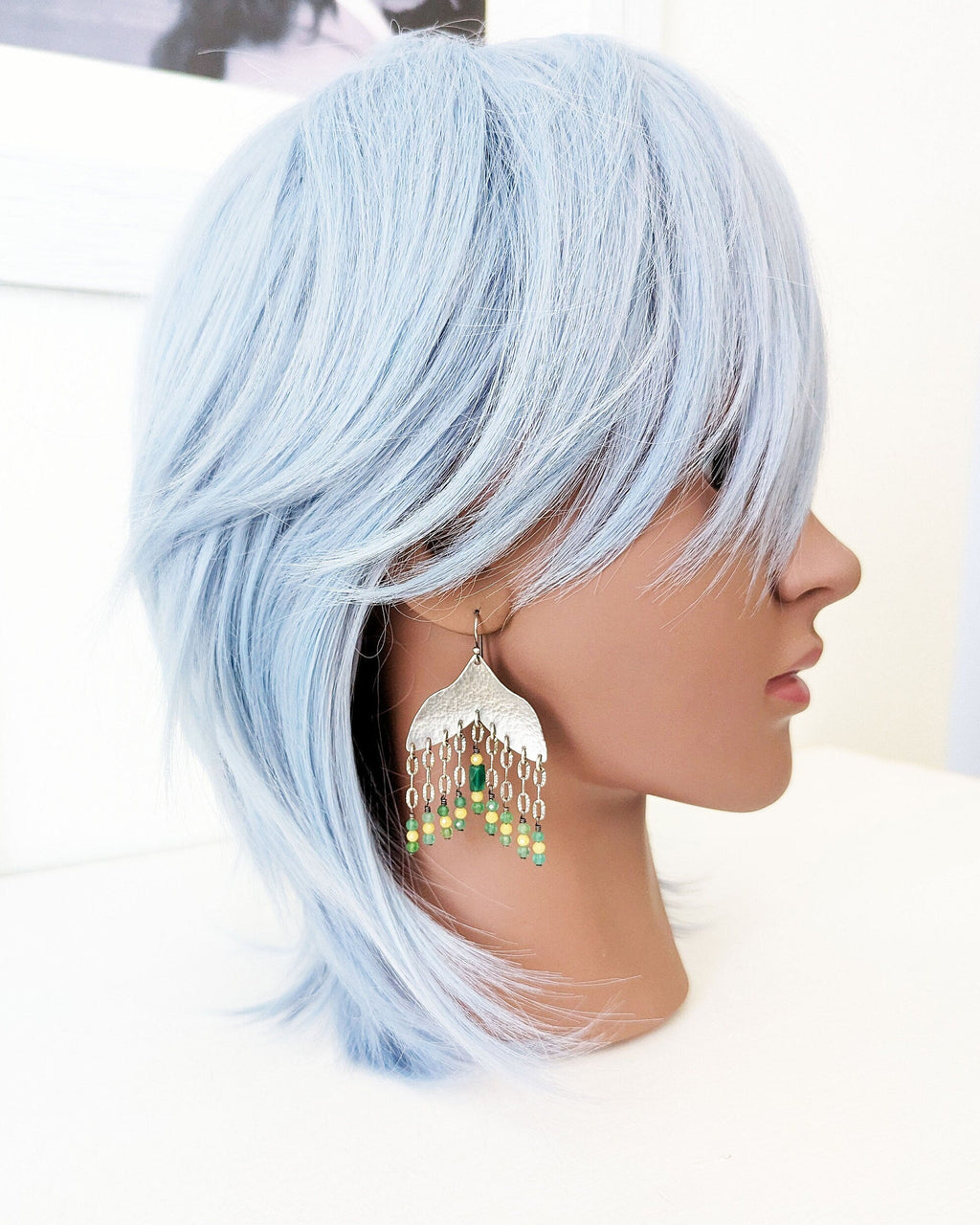Spring inspired green and yellow dangle earrings on mannequin for scale