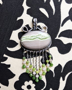 Nature-inspired statement pendant with pale grey and green tones