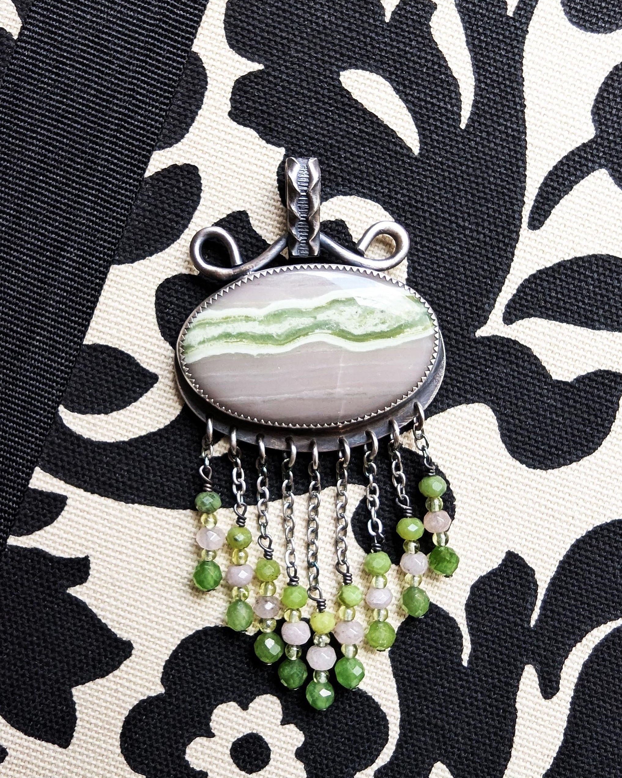Nature-inspired statement pendant with pale grey and green tones