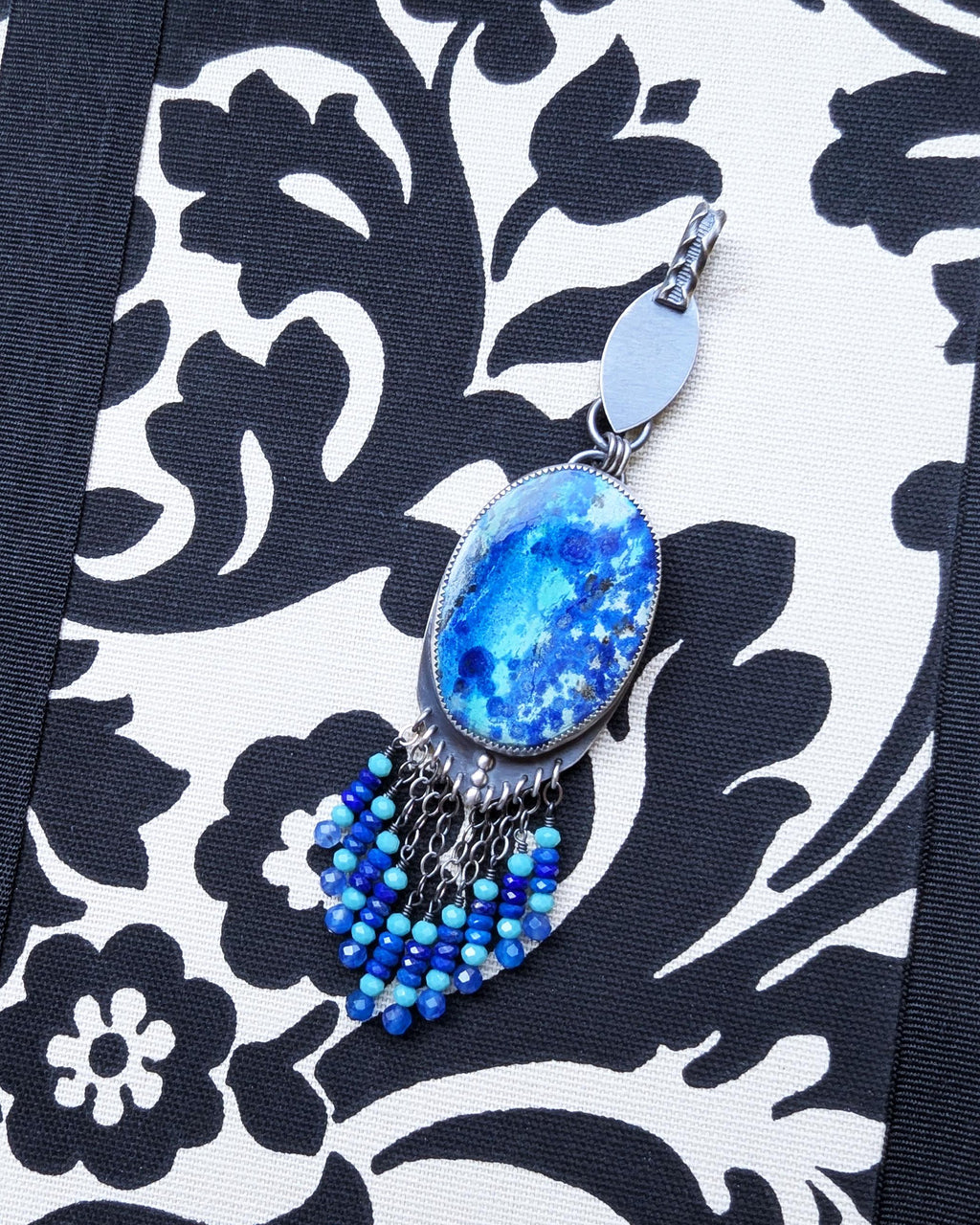 Oxidized sterling silver pendant with marquis bail and ocean-blue stone