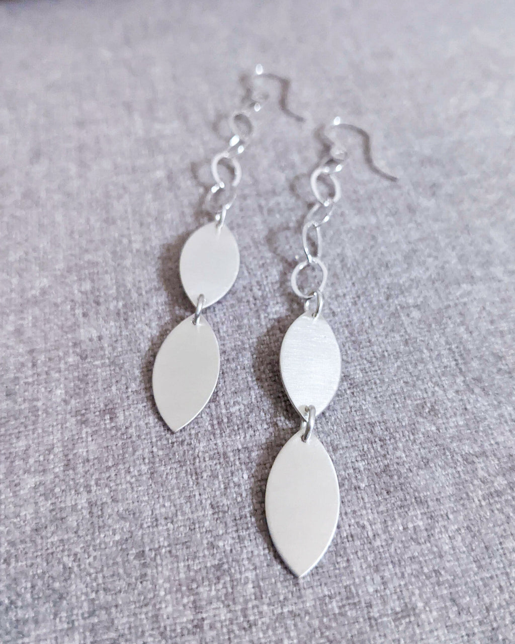Minimalist leaf earrings with polished metallic accents