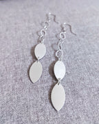 Minimalist leaf earrings with polished metallic accents