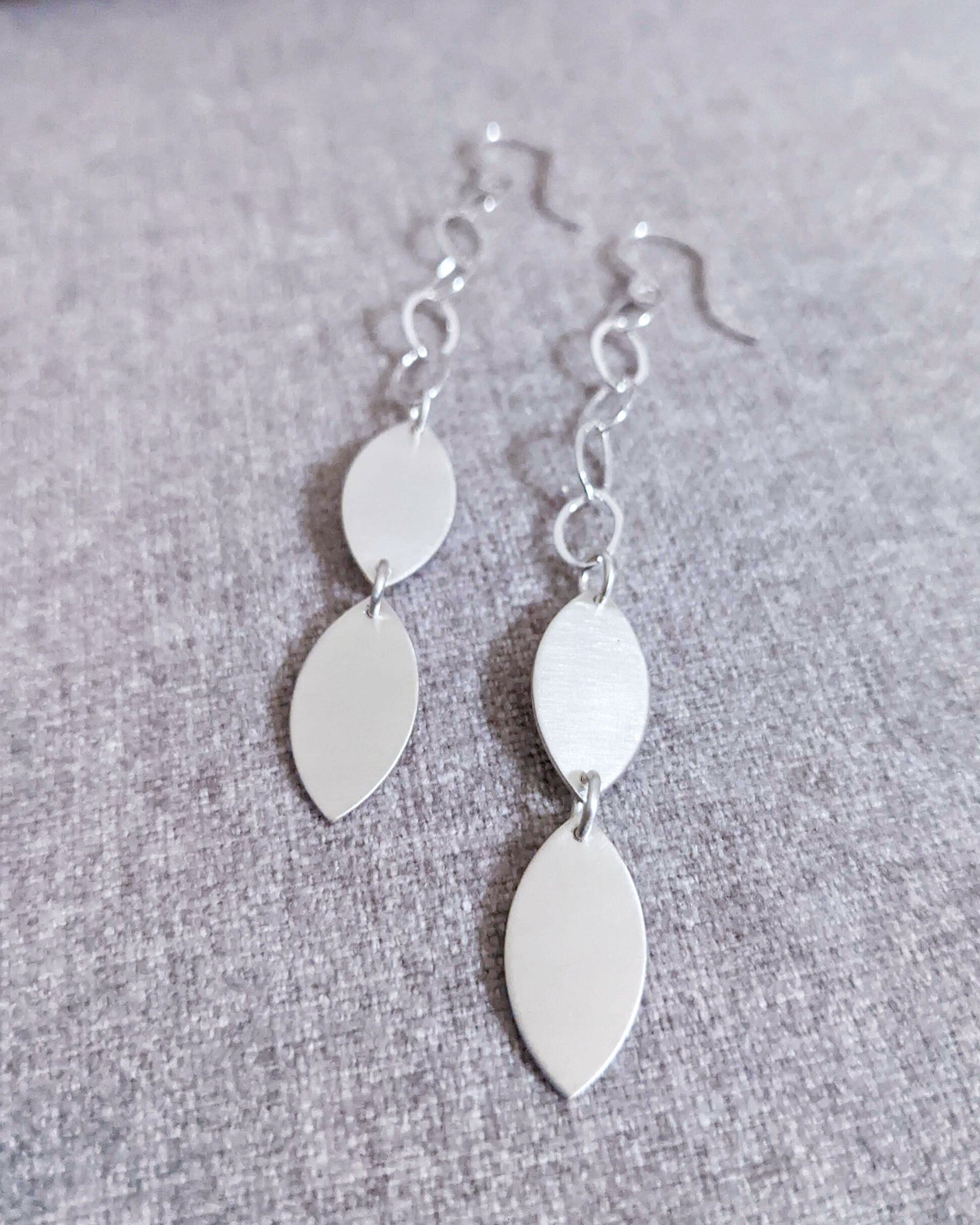 Minimalist leaf earrings with polished metallic accents