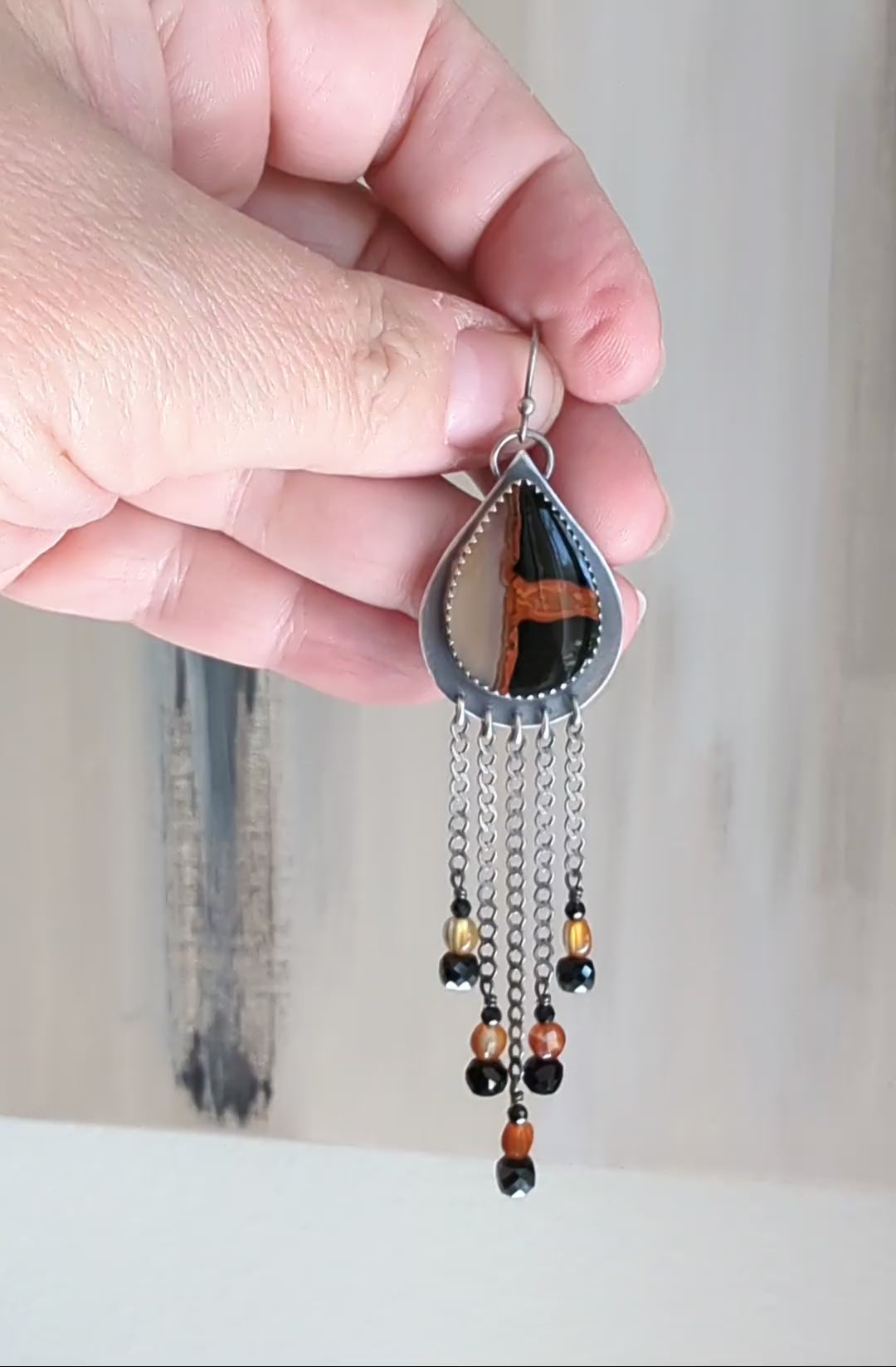 Video of edgy boho earrings with carnelian and black spinel accents by Rebellenhaus