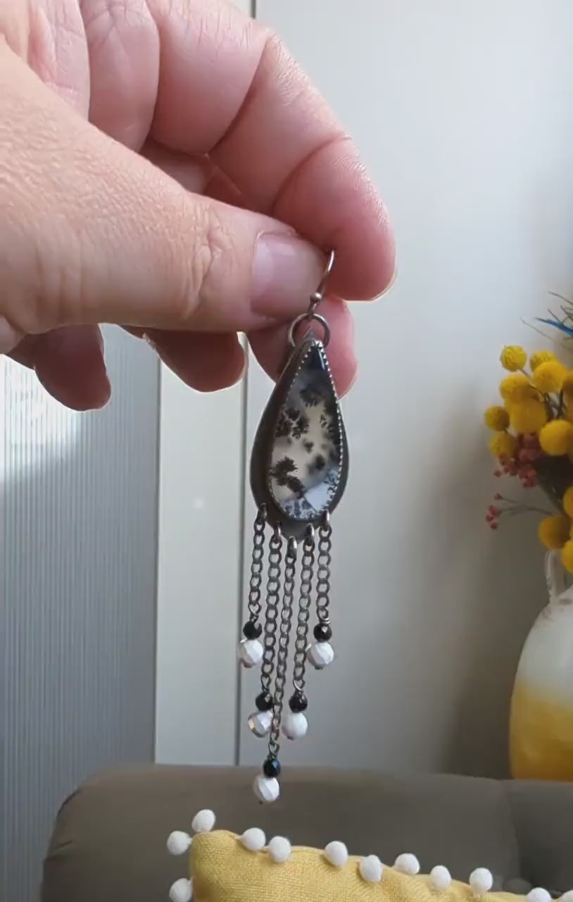 Video of modern western opal earrings with ivory and charcoal contrast