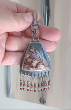 Video of statement necklace with shield shape and cascading fringe by Rebellenhaus