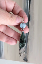 Video of unique gemstone earrings with radiating seraphinite patterns by Rebellenhaus