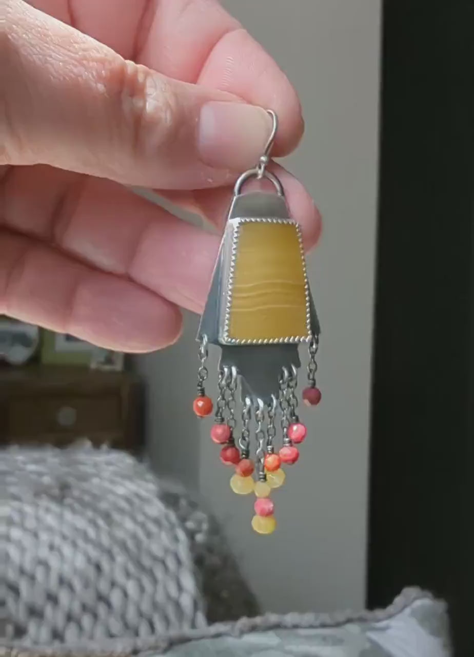 Video of golden calcite earrings with pretty coral beads by Rebellenhaus