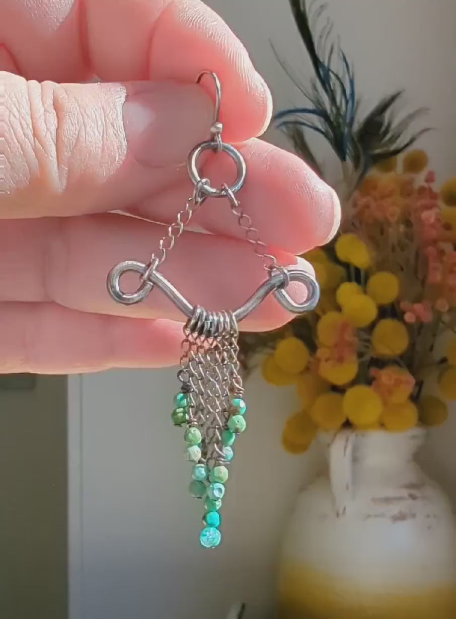 Video of oxidized sterling silver earrings featuring vibrant turquoise bead movement