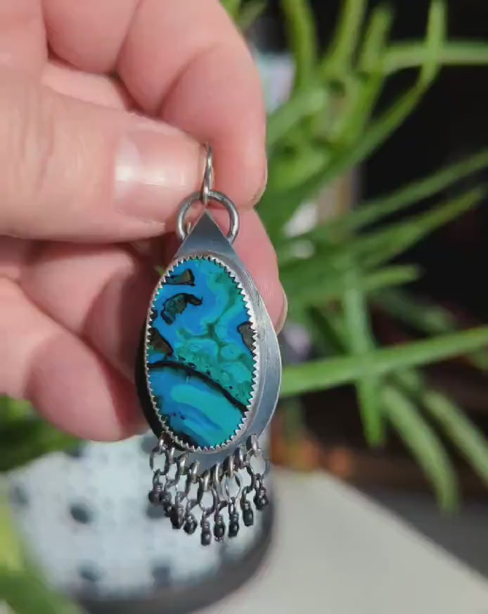 Video of blue green stone with black bead fringe