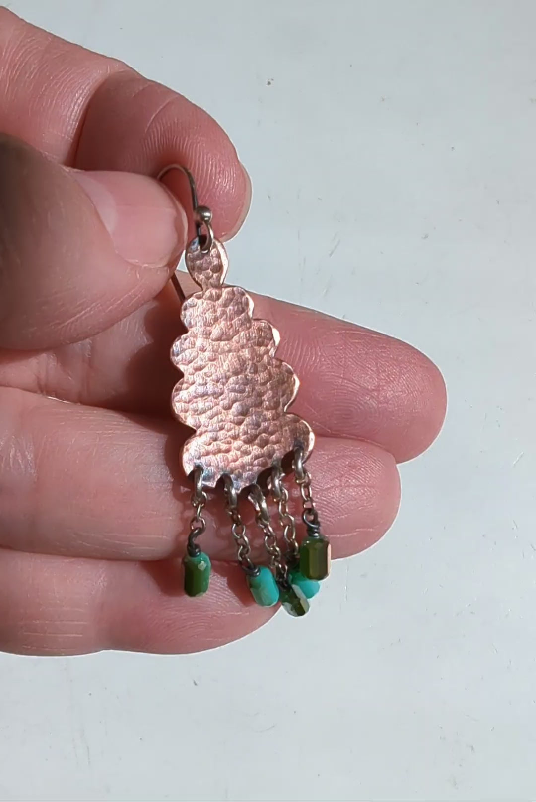 Video of handmade copper earrings with scalloped design and bead fringe by Rebellenhaus