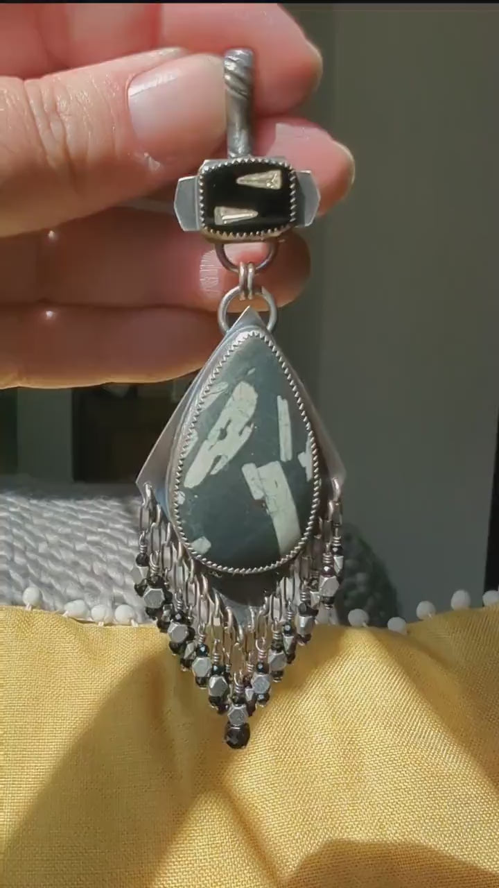 Video of a one of a kind Chinese writing stone jewelry pendant by Rebellenhaus
