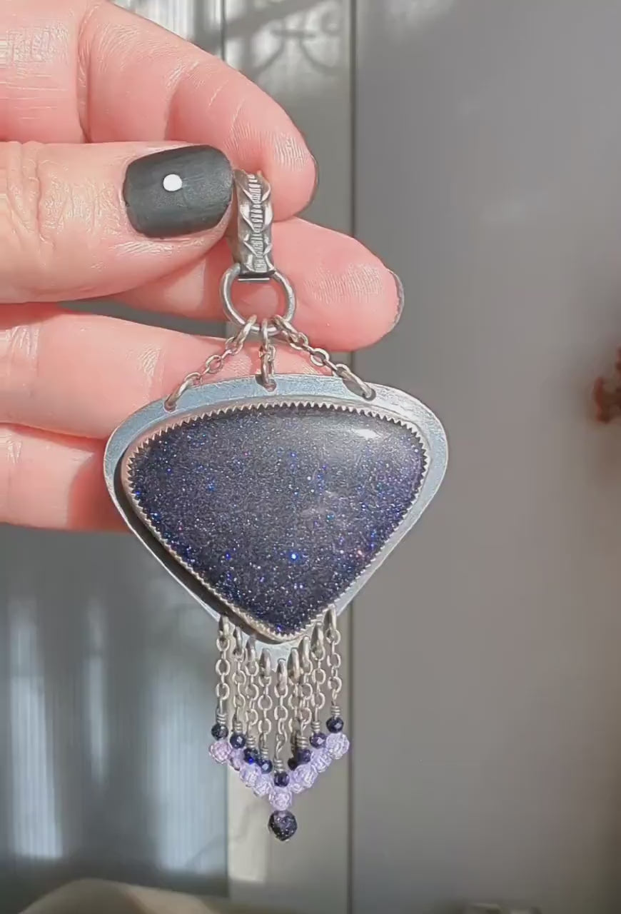 Video of bold artisan sterling silver pendant with night-sky inspired shimmer