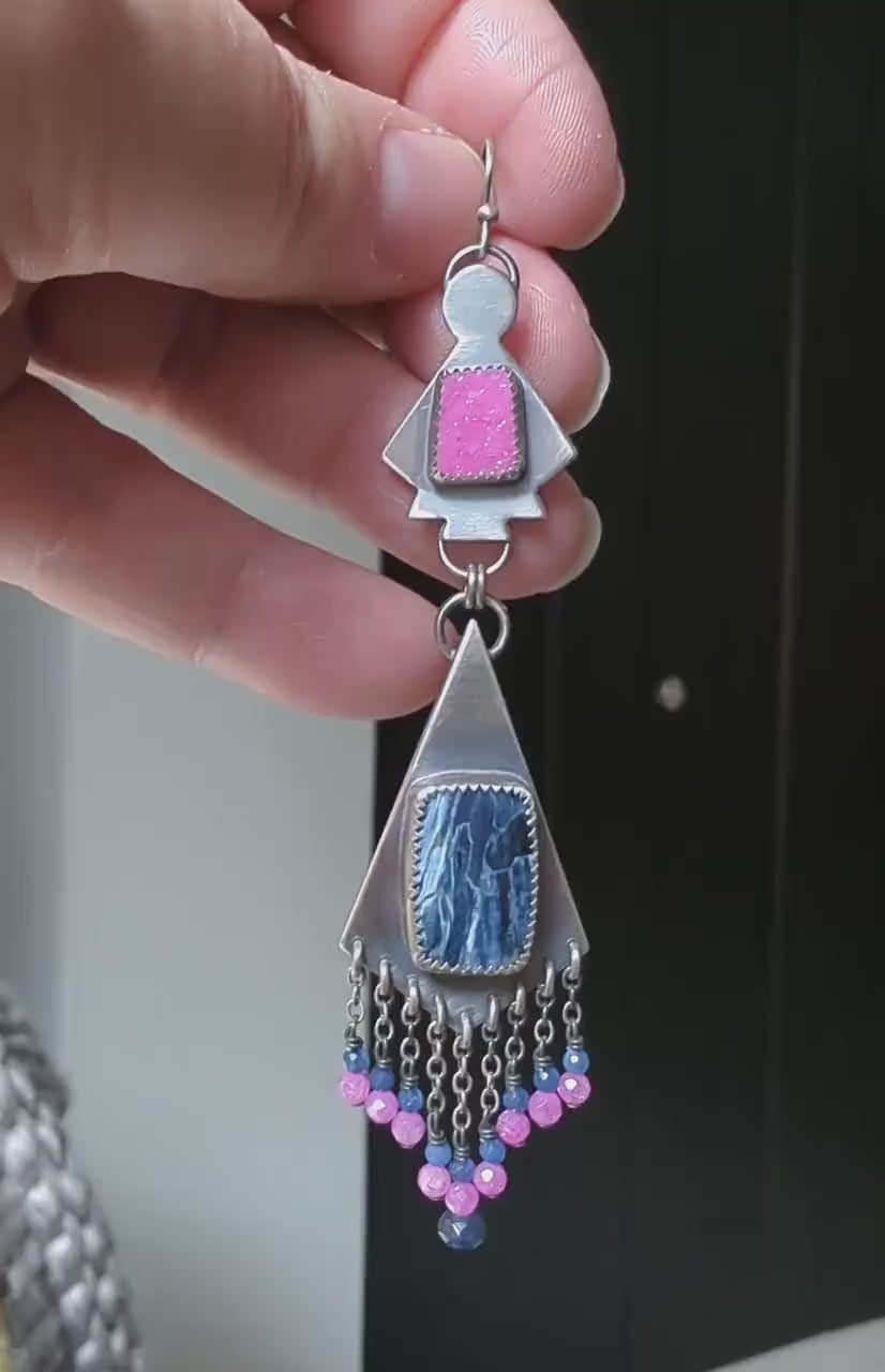 Video of collector gemstone earrings with dramatic pink and blue contrast