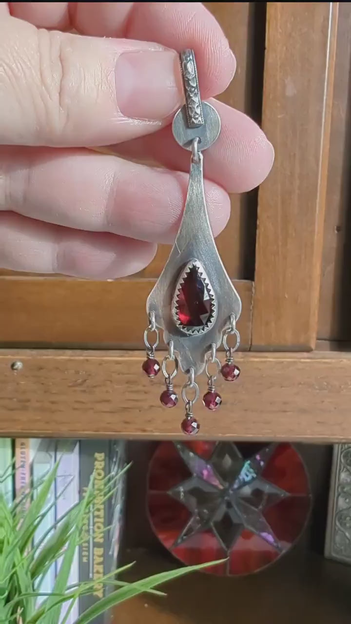 Video of collector artisan pendant featuring glowing red garnet