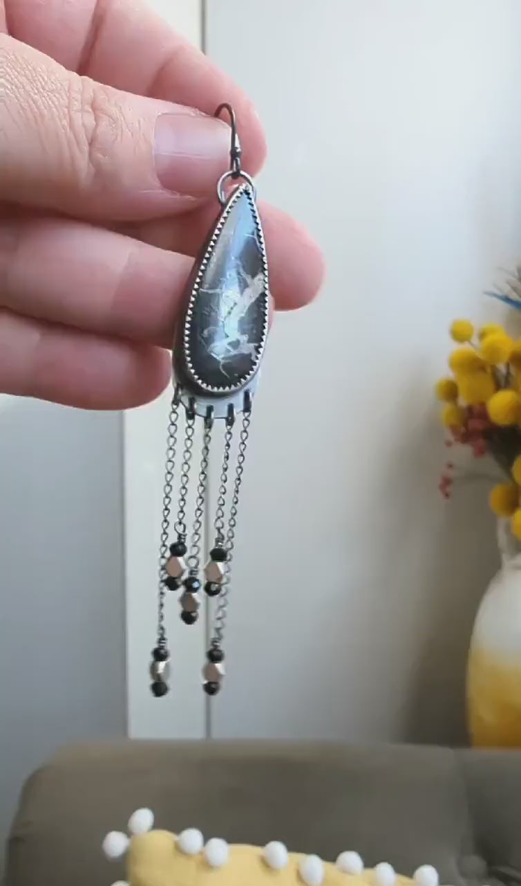 Video of monochrome gemstone earrings with electric storm-inspired contrast
