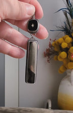 Video of modern heirloom pendant featuring black glass and metallic mineral