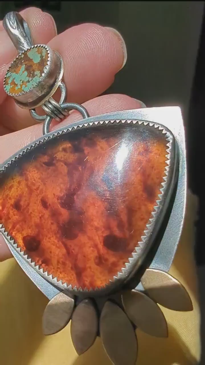 Video of one of a kind turquoise and amber gemstone pendant by Rebellenhaus