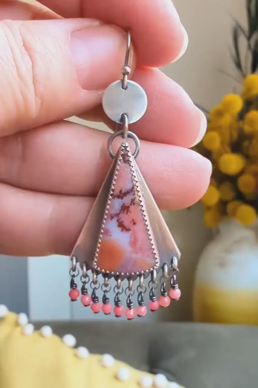 Video of bold tropical gemstone earrings with silver coin drop design