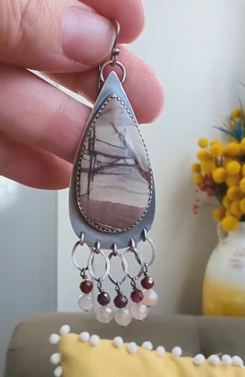 Video of collector gemstone earrings featuring rhyolite jasper and moonstone detail